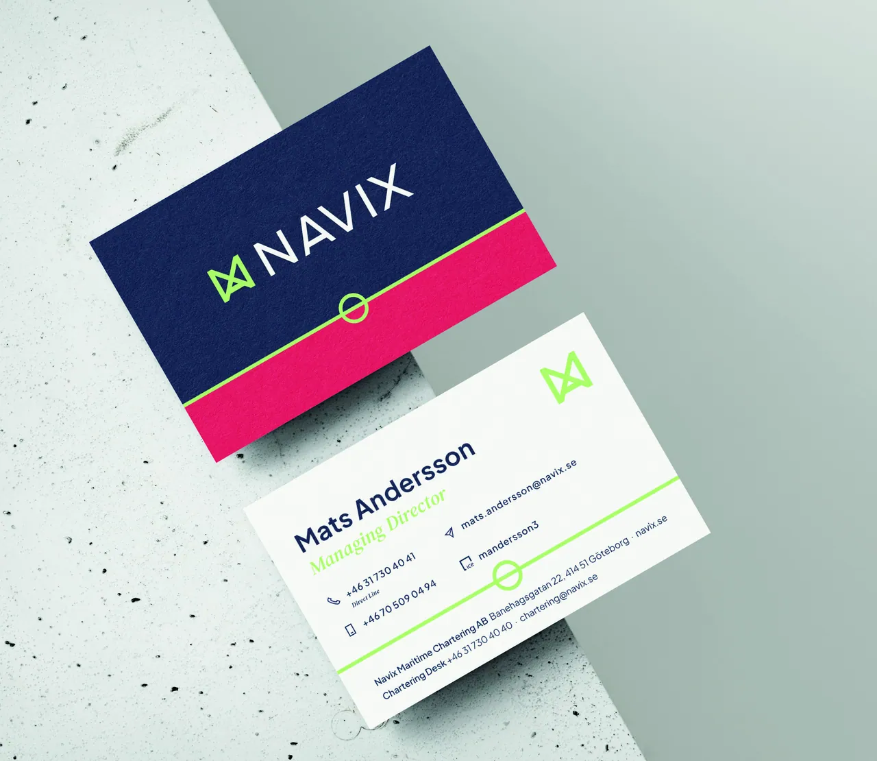 Navix business cards: a Deep Sea Blue front with a Brand Red band and a Brand Green Loadline, and a white reverse with Deep Sea Blue type.