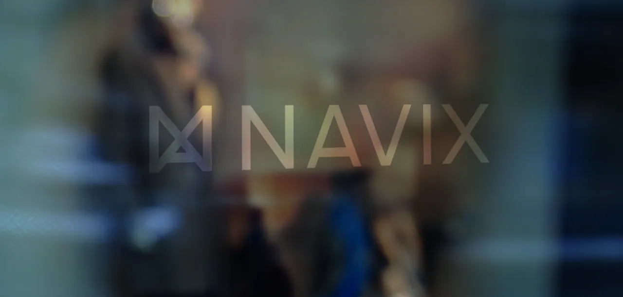 The Navix logotype as a frosted-glass graphic on an office glass wall, with blurred figures behind it.