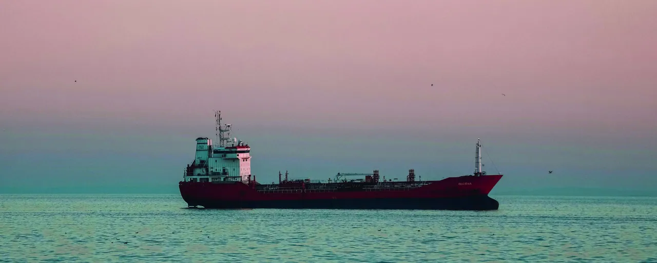 Red product tanker at sea at dusk, framed with a cut corner inside a Deep Sea Blue banner with the Navix logotype
